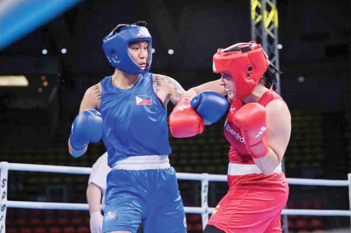 Hergie Bacyadan (left) became the fifth Filipino boxer to earn a qualification to the Paris Olympics. She pointed Venezuela’s Maryelis Yriza in the women’s 75-kilogram division event of the 2nd World Boxing Qualification for the Paris Games in Thailand. PHOTO COURTESY OF ABAP