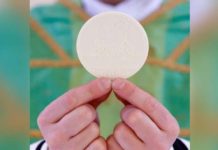 A priest holds the Holy Communion by his fingertips. Also called the Eucharist, Holy Communion is a sacrament that commemorates the Last Supper. GETTY IMAGES