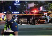 Police and rescuers stand next to a car involved in an accident that resulted in several people killed and injured in central Seoul, South Korea on July 1, 2024. REUTERS