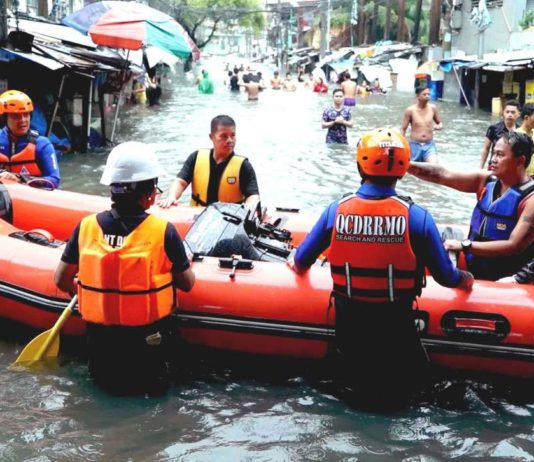 Quezon City Disaster Risk Reduction and Management Office’s search and rescue personnel prepare a motorized rubber boat for the evacuation of residents along Araneta Avenue, Quezon City on July 24, 2024. Floodwaters in the area rose waist-deep as the southwest monsoon enhanced by Typhoon Carina continued to dump heavy rains. PNA
