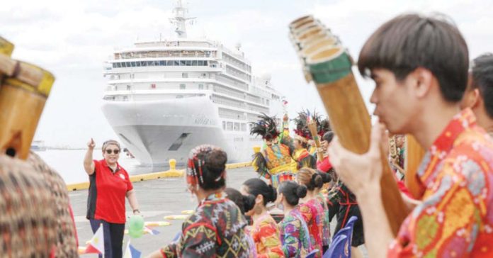 Passengers onboard the Silver Spirit cruise ship are welcomed by tourism and city government officials at the Manila South Harbor on February 15, 2023. PNA PHOTO BY YANCY LIM