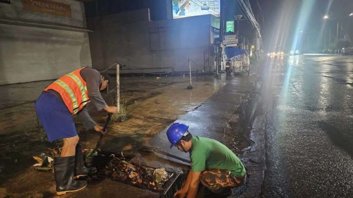 Personnel of Bacolod City Disaster Risk Reduction and Management Office conducted clearing of drainage inlets clogged by mixed garbage on Araneta Street and Araneta Street-Alijis Road Old Airport early Wednesday morning, July 24. BACOLOD CDRRMO PHOTO