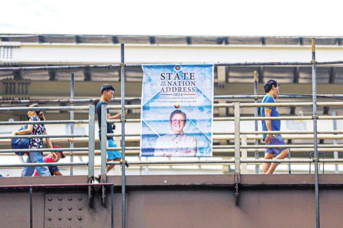 SONA-READY. A tarpaulin of President Ferdinand R. Marcos Jr. is seen on a footbridge in Commonwealth Avenue, Quezon City. The nation will listen to the third State of the Nation Address of the President today, July 22. PNA