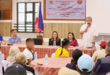 Gov. Fredenil Castro (standing, right) leads the distribution of financial assistance to 94 former rebels from Capiz on Tuesday, July 23. CAPIZ PROV’L GOV’T COMMUNICATIONS GROUP/FACEBOOK PHOTO