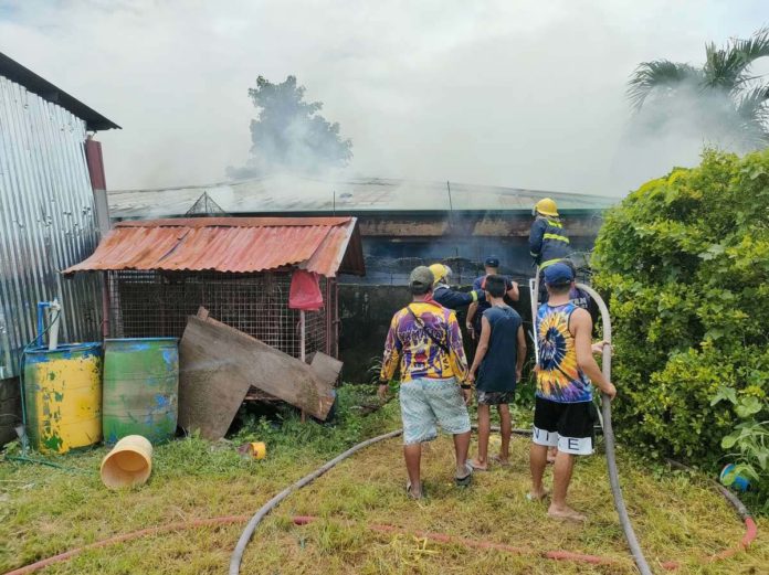 Firefighters and residents joined forces to extinguish a fire that engulfed a house in Barangay Cubay, Jaro, Iloilo City on Sunday, July 28. AJ PALCULLO/PN