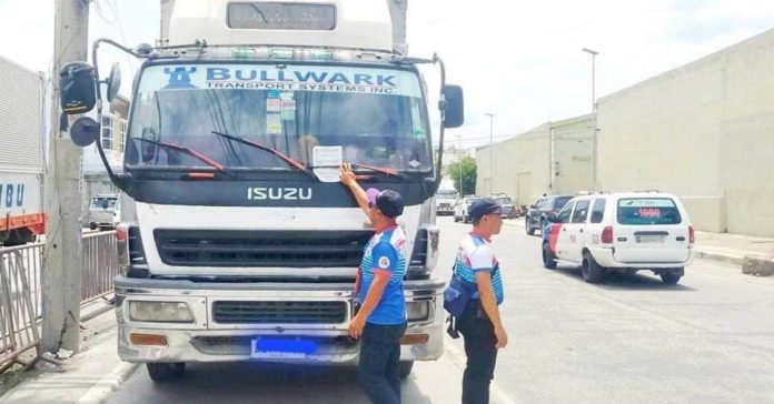 The Land Transportation Office says crackdown on illegally parked vehicles involves ticketing and towing vehicles that are found parked illegally on the national highway. Photo shows a truck parked illegally beside the road in Iloilo City. JERRY TREÑAS/FACEBOOK PHOTO