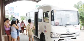 Passengers board a minibus in Iloilo City. Consolidated transport cooperatives and/or companies have secured millions of pesos in bank loans to buy minibuses in line with the Public Utility Vehicle Modernization Program. Suspending the program, they say, would be detrimental to their operation. IME SORNITO/PN