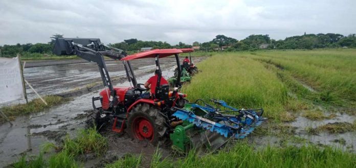 This is a field demonstration of a tractor, front loader, levee maker and rotating disc plow at the Western Visayas Agricultural Research Center in Jaro, Iloilo City.