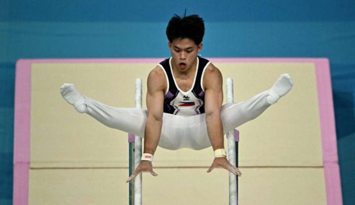 The Philippines’ Carlos Edriel Yulo competes in the parallel bars event of the artistic gymnastics men’s qualification during the Paris Olympics 2024 at the Bercy Arena in Paris, on July 27, 2024. Photo by Lionel BONAVENTURE / AFP