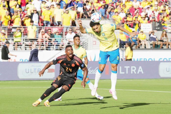 Brazil defender Marquinhos (4) heads the ball away from Colombia forward Jhon Cordoba (24). PHOTO COURTESY OF DARREN YAMASHITA/USA TODAY SPORTS