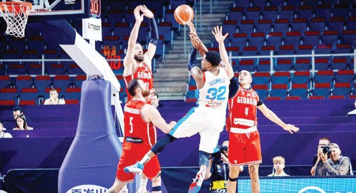 Gilas Pilipinas’ Justin Brownlee is undaunted by the tight defense of Georgia and goes for a shot in the FIBA Olympic Qualifying Tournament in Riga, Latvia last night. FIBA PHOTO