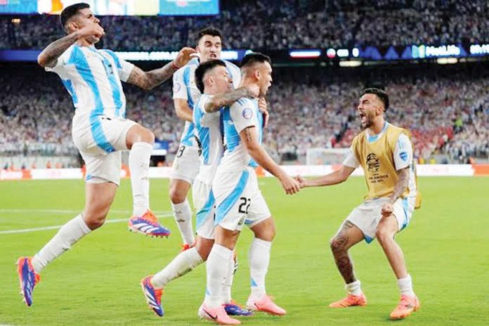 Argentina teammates run to Lautaro Martinez after he drained the game-winner against Colombia. AP PHOTO