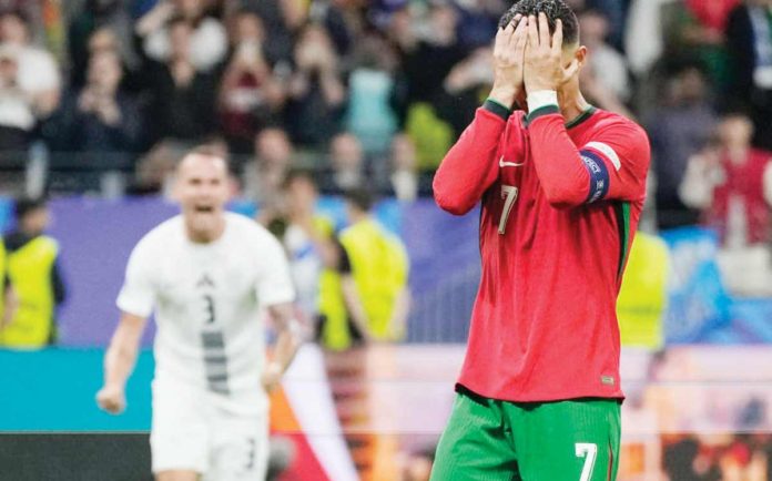 Portugal’s Cristiano Ronaldo covers his face in disappointment after missing a penalty kick during the extra-time of the knockout game against Slovenia. AP PHOTO