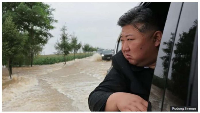 North Korea leader Kim Jong Un travels through a flooded area. RODONG SINMUN