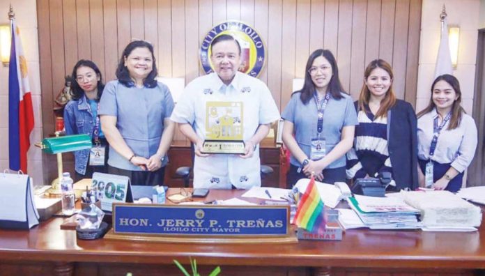 The team from the Local Economic Development and Investment Promotion Office (LEDIPO) and Iloilo City MICE Center headed by Ms. Lea Lara (2nd from left) presents to Mayor Jerry P. Treñas (3rd from left) the city's plaque of recognition as the Philippines' fifth most competitive highly urbanized city.