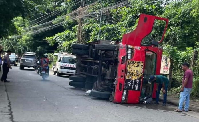 A driver was injured when a delivery truck turned turtle on Hemingway Street, Barangay Tiza, Roxas City on Thursday morning, August 15. RADYO MARAGTAS/FACEBOOK PHOTO