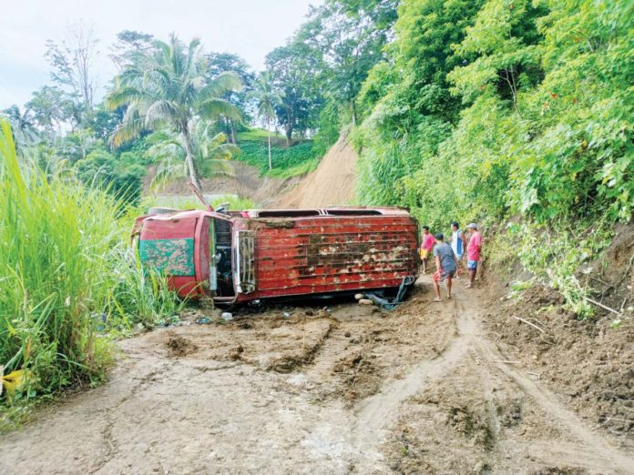 Two children aged five and 13 died and 16 other passengers were injured after a jeepney skidded on a slippery curve and overturned in Barangay Cagay, Leon, Iloilo on Tuesday morning, August 13. AJ PALCULLO/PN