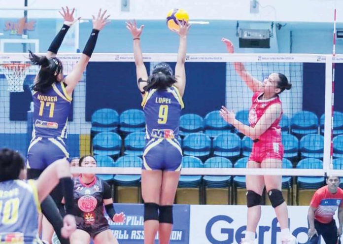 Negrense Erika Deloria of Biñan Tatak Gel 1-Pacman Partylist Volley Angels goes for an attack against a Negros-ICC Blue Hawks defender. MPVA PHOTO