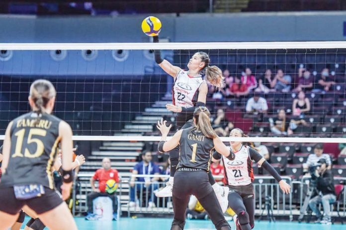 Chery Tiggo Crossovers’ Pauline Gaston tries a drop ball against the defense of ZUS Coffee Thunderbelles. PVL PHOTO