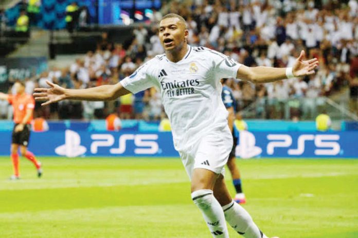 Kylian Mbappé celebrates after scoring his first goal as a member of Real Madrid CF. GETTY IMAGES