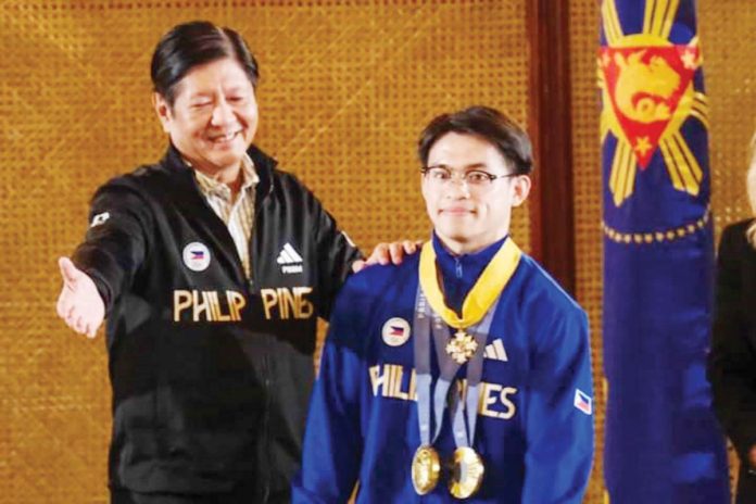 President Ferdinand Marcos, Jr. confers the Presidential Medal of Merit to Filipino gymnast Carlos Edriel Yulo, who captured two gold medals in the 2024 Paris Olympics. PHOTO COURTESY OF PPA POOL