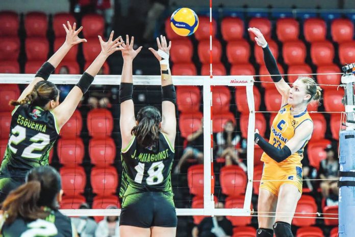 Capital1 Solar Energy Solar Spikers’ Marina Tushova converts against two NxLed Chameleons defenders. PVL PHOTO