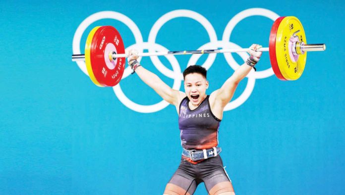 Filipina weightlifter Elreen Ann Ando screams after completing her clear and jerk performance. REUTERS