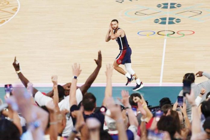 Team USA’s Stephen Curry gestures to the French crowd after hitting a three-pointer during their 2024 Paris Olympics gold medal game against France. JAMIE SQUIRE/GETTY IMAGES