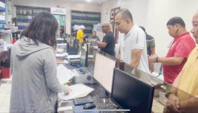 Retired Police Major Charlie Sustento Jr. (left) submits his letter request to the local government unit of Dumangas, Iloilo for copies of documents regarding the operations of Dumangas Port on Tuesday, August 27.