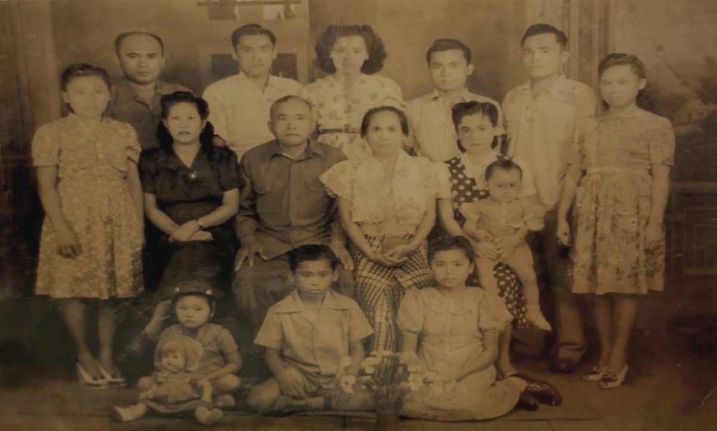 First Generation of Falco Family: (Back row, L to R) Jose, Salvador, Aurora, Zoilo, Guillermo and Belen.  (Middle row, L to R) Ismaelita, Adoracion (wife of Jose), Francisco (Father), Paz (Mother), Patria (wife of Guillermo), and on her lap is their first born daughter, Cecilia.