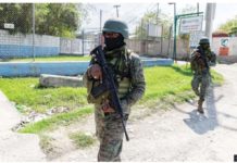 Haitian soldiers stand guard at the entrance to Port-au-Prince international airport after armed gang members exchanged gunfire with police and soldiers around the airport. GETTY IMAGES