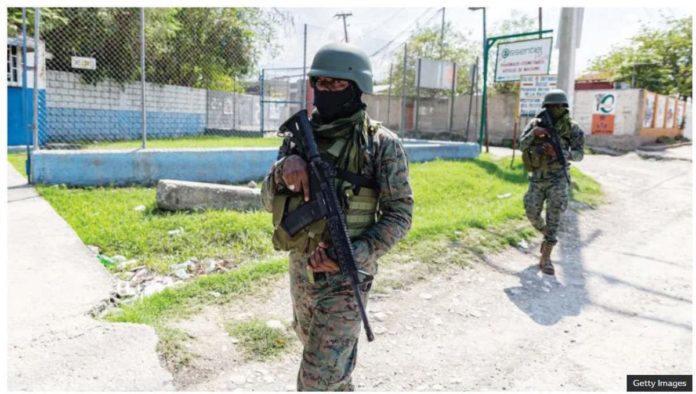 Haitian soldiers stand guard at the entrance to Port-au-Prince international airport after armed gang members exchanged gunfire with police and soldiers around the airport. GETTY IMAGES