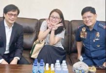 Department of Interior and Local Government secretary Benhur Abalos (left) and Philippine National Police chief Rommel Marbil (right) are pictured with a candid-looking arrested fugitive Alice Guo in Indonesia. NBI PHOTO