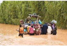 People wading through floodwaters water in Niger. AFP