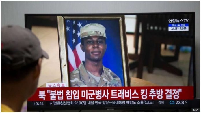 A man watches the news showing US soldier Travis King on screen, at his home in Seoul, South Korea. EPA