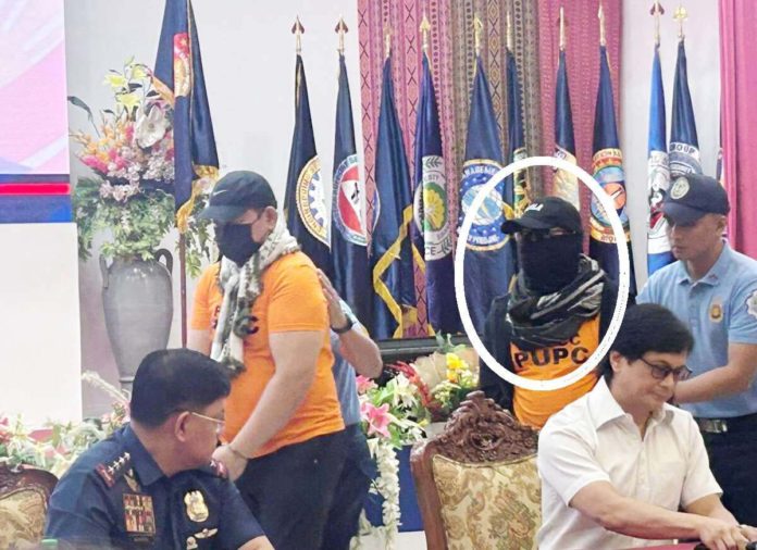 Pastor Apollo Quiboloy is unrecognizable as he wears shades, mask, a black scarf and a hat bearing the word “Agila” when he is presented during a press conference in Camp Crame on Monday, a day after he was taken into custody. Quiboloy was presented by Interior Secretary Benjamin Abalos Jr. PHILIPPINE DAILY INQUIRER