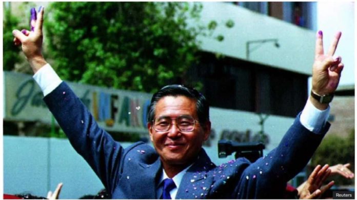 Peruvian President Alberto Fujimori gives the victory sign with ink-stained fingers after voting in the nation's first-ever constitutional referendum, October 31, 1993. Fujimori was in power from 1990 until 2000. REUTERS