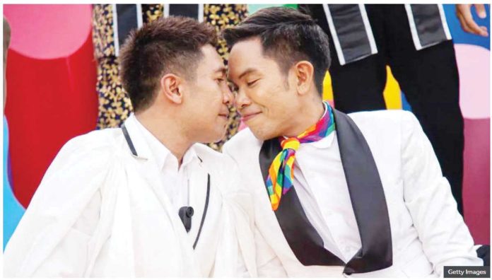 A gay couple - two men - sit close together with their heads touching as they pose for a photo during a celebration hosted by the Thai government to mark the passage of the marriage equality bill. Gay couples in Thailand can register their unions from January 22 next year. GETTY IMAGES