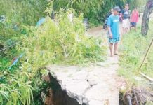 Heavy rains brought by the southwest monsoon, or habagat, damaged the Igbarawan road going to barangays Salaguiawan and Magarang in Patnongon, Antique. JOSEPH MAGDAYAO PHOTO