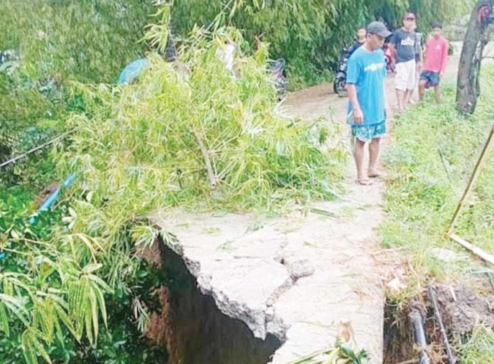 Heavy rains brought by the southwest monsoon, or habagat, damaged the Igbarawan road going to barangays Salaguiawan and Magarang in Patnongon, Antique. JOSEPH MAGDAYAO PHOTO