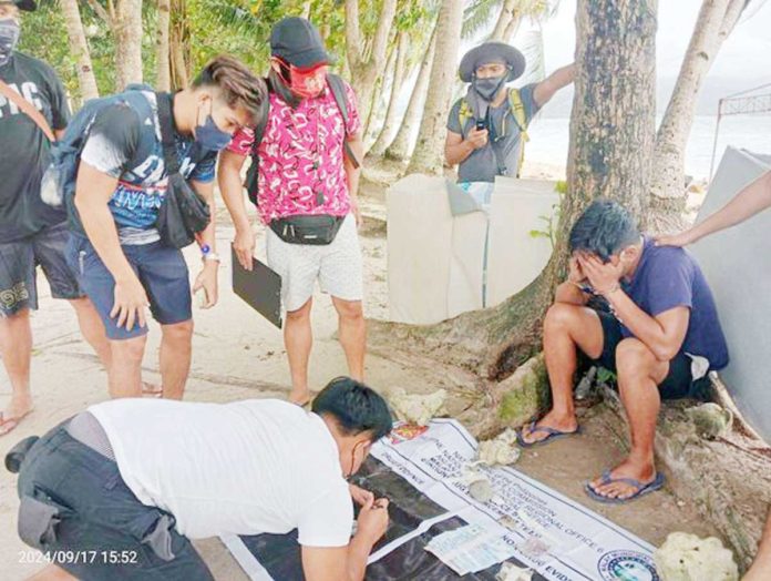 A 28-year-old drug suspect (right) from Barangay Igbong, Barotac Nuevo, Iloilo yielded P30,100 worth of suspected shabu in a buy-bust operation in Boracay Island on Tuesday, Sept. 17, 2024. REYNALD BANDIOLA / RADYO TODO AKLAN 88.5 FM PHOTO