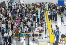 Outbound travelers queue at the Ninoy Aquino International Airport Terminal 3 check-in and immigration counters. MARIA TAN/ABS-CBN NEWS PHOTO