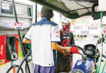 A gasoline station clerk refills a tricycle’s tank at a station in Manila. GEORGE CALVELO/ABS-CBN NEWS FILE PHOTO