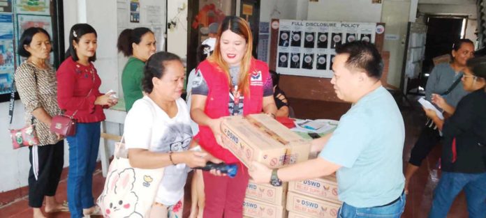 Monsoon-displaced individuals in Makato, Aklan queue to receive family food packs from the Department of Social Welfare and Development. During the habagat season, the predominant wind flow brings high levels of humidity and substantial rainfall. This often leads to intense and prolonged periods of rain, which often result in flooding, especially in low-lying and coastal areas. PHOTOS BY DSWD WESTERN VISAYAS