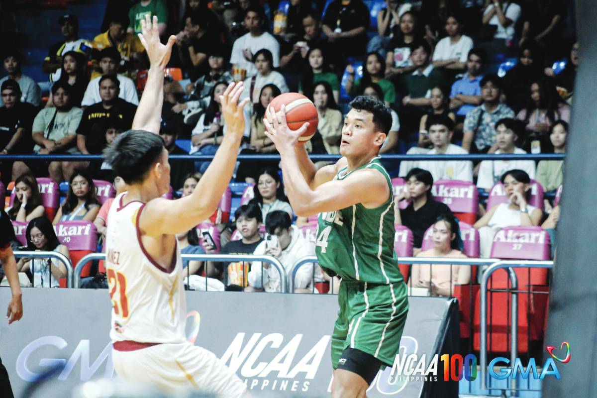 College of St. Benilde Blazers’ Allen Liwag looks to pass the ball while being bothered by a University of Perpetual Help Altas’ defender. PHOTO COURTESY OF NCAA/GMA SPORTS