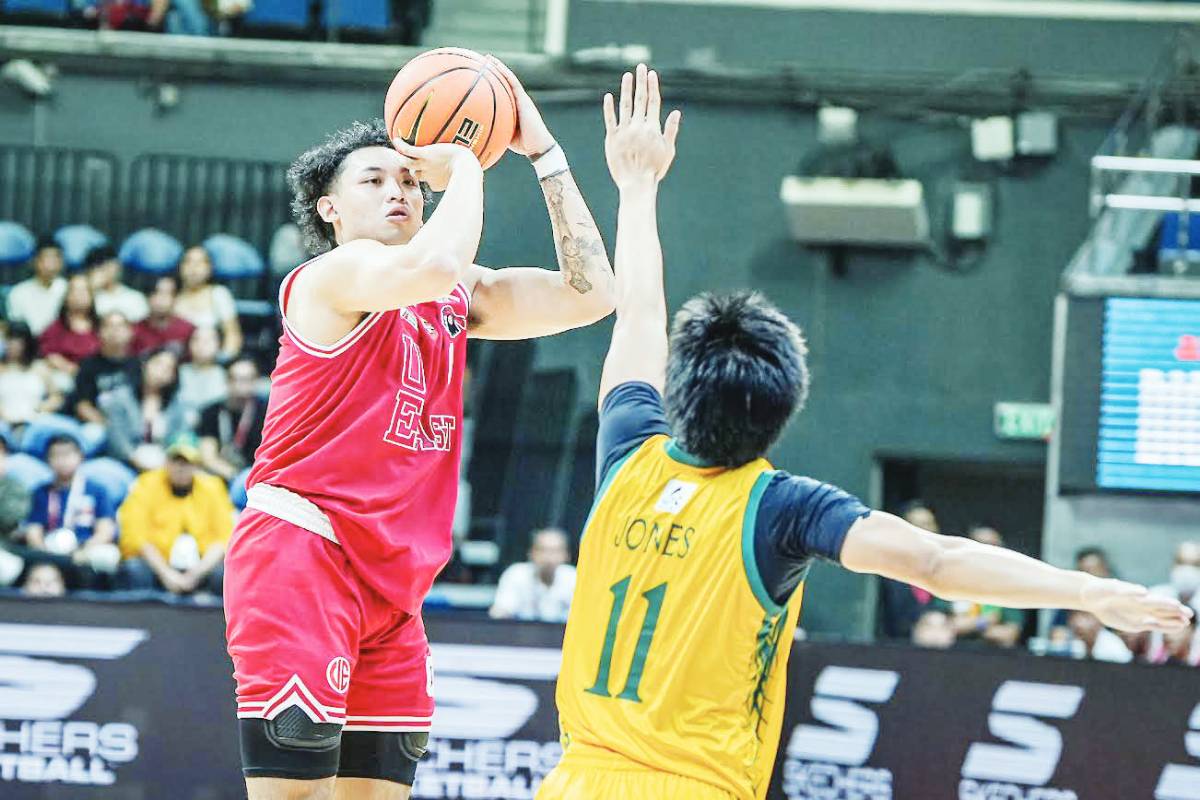 University of the East Red Warriors’ Ethan Galang shoots over a Far Eastern University Tamaraws defender. UAAP PHOTO