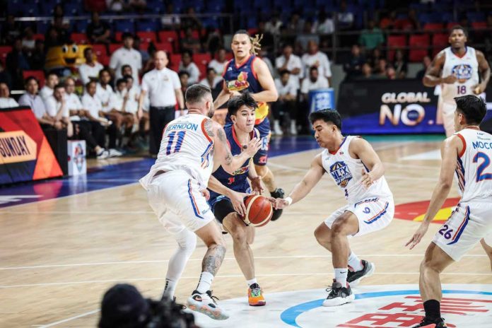 Rain or Shine Elasto Painters’ Adrian Nocum protects the ball while being defended by NLEX Road Warriors’ Robbie Herndon and Dominick Fajardo. PBA PHOTO