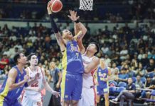 TNT Tropang Giga’s John Paul Erram scores against the defense of NorthPort Batang Pier’s Damie Cuntapay. PBA PHOTO