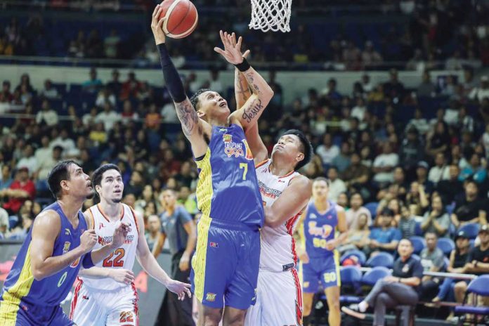 TNT Tropang Giga’s John Paul Erram scores against the defense of NorthPort Batang Pier’s Damie Cuntapay. PBA PHOTO