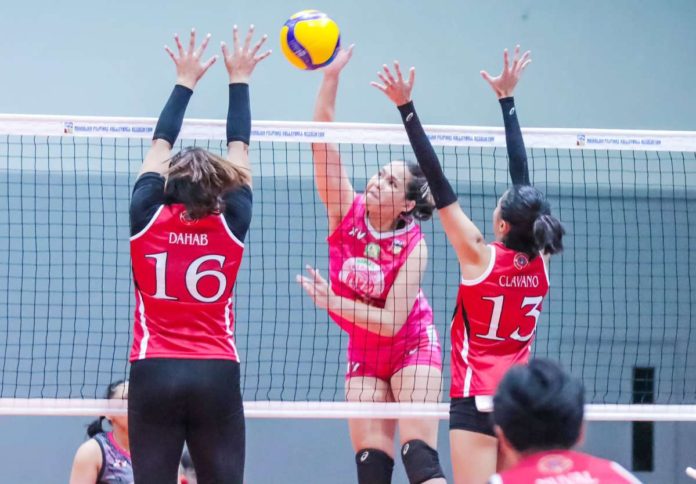 Negrense Erika Jin Deloria of Biñan Tatak Gel 1-Pacman Partylist Volley Angels smashes the ball against two defenders. MPVA PHOTO